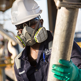 Worker in hard hat, face mask and gloves